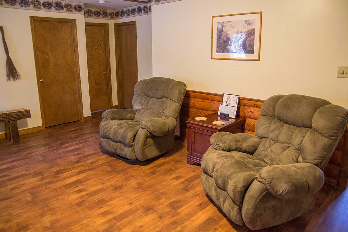 Cabin Living room showing recliners and log accents